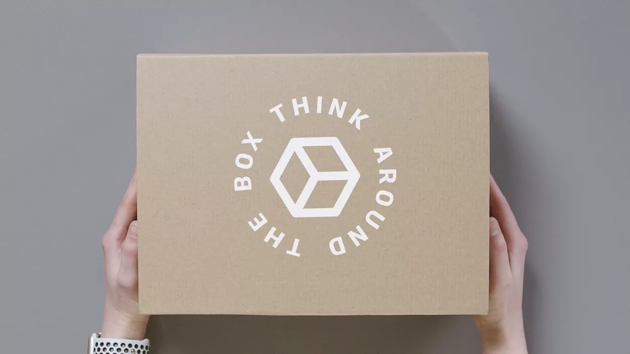hand holding box of DS Smith with think around the box text